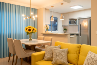 Sala de estar moderna com efeitos de iluminação que destacam a decoração, incluindo uma luminária decorativa, iluminação pendente e luz natural, criando um ambiente acolhedor e bem iluminado.