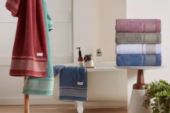 Exposição de toalhas de banho com diferentes cores e estampas, destacando as tendências para o ABUP Show 2026